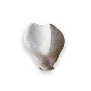 A white, textured, heart-shaped object displayed against a plain white background.
