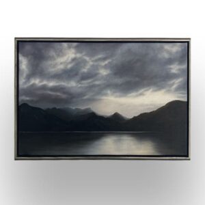 A framed painting depicts a dark, cloudy sky over distant mountains with their reflection visible on a calm lake.