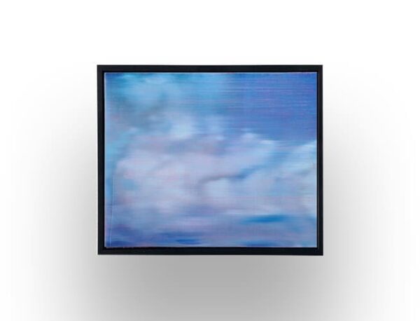 A framed painting or print depicting a blurry, abstract sky with blue and white tones, mounted on a white wall.