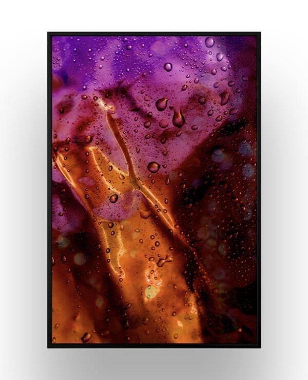 Abstract image featuring vibrant purple and orange colors with water droplets scattered across the surface.