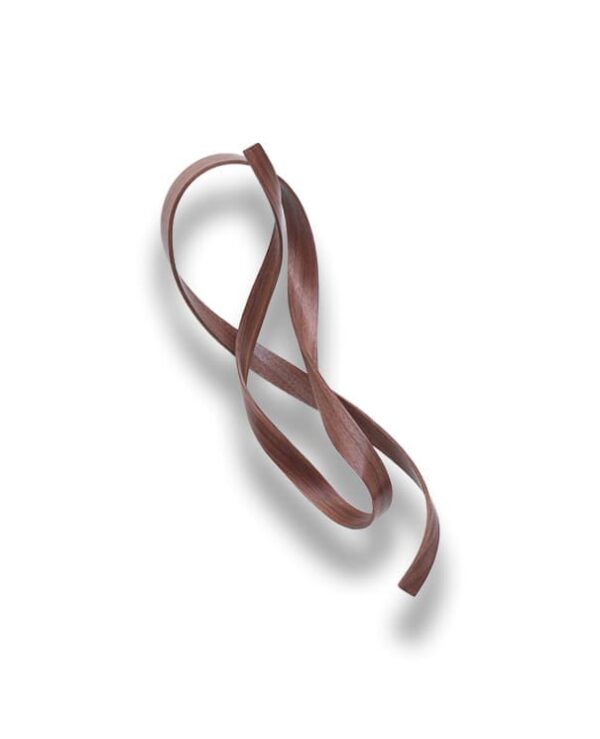 A single piece of flat, brown ribbon-like material is looped and twisted on a white background, casting a soft shadow.