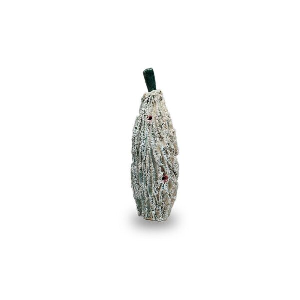 A decorative, textured cucumber ornament with a green stem and small red accents, displayed on a white background.